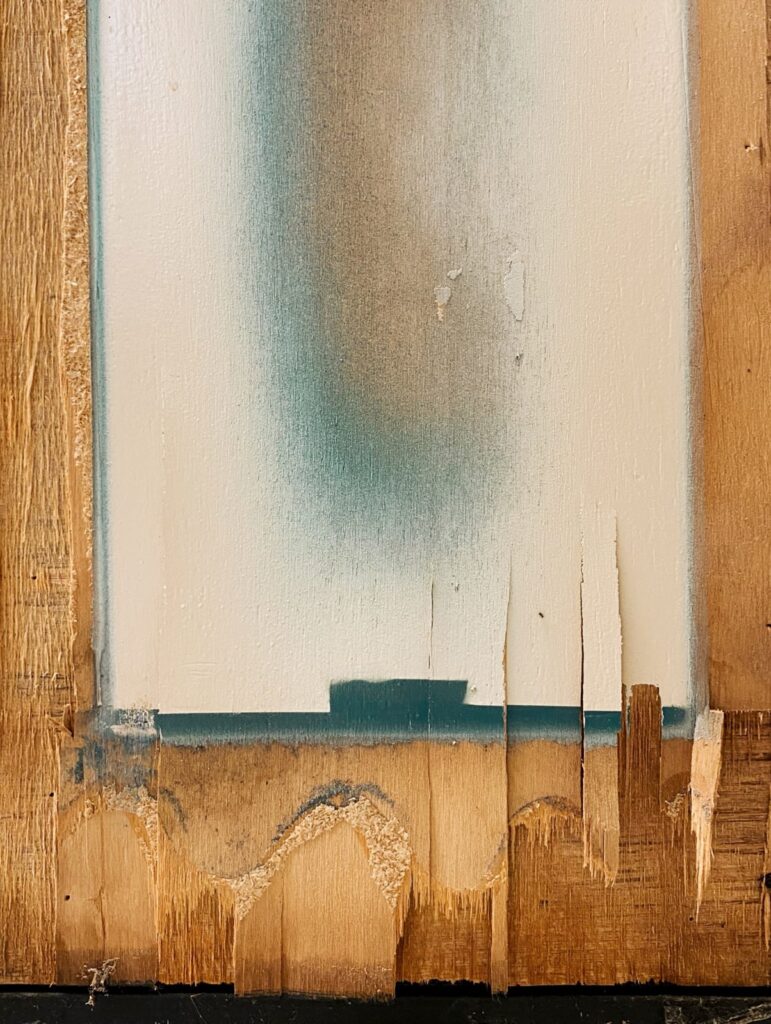 detail of wood painted in white and blue